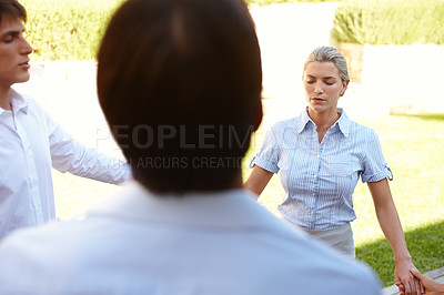 Buy stock photo Shot of a group of colleagues meditating while on a business retreat