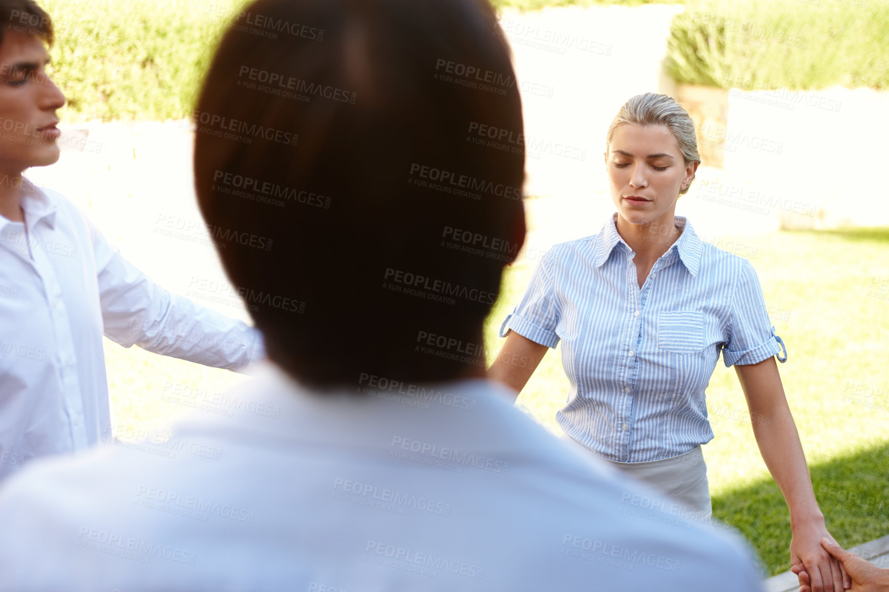 Buy stock photo Shot of a group of colleagues meditating while on a business retreat