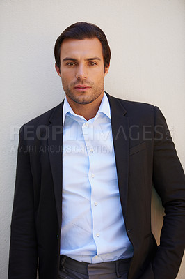 Buy stock photo Portrait of a handsome and well-dressed businessman standing outside