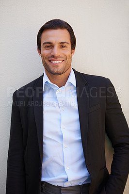 Buy stock photo Shot of a handsome and well-dressed businessman smiling at the camera