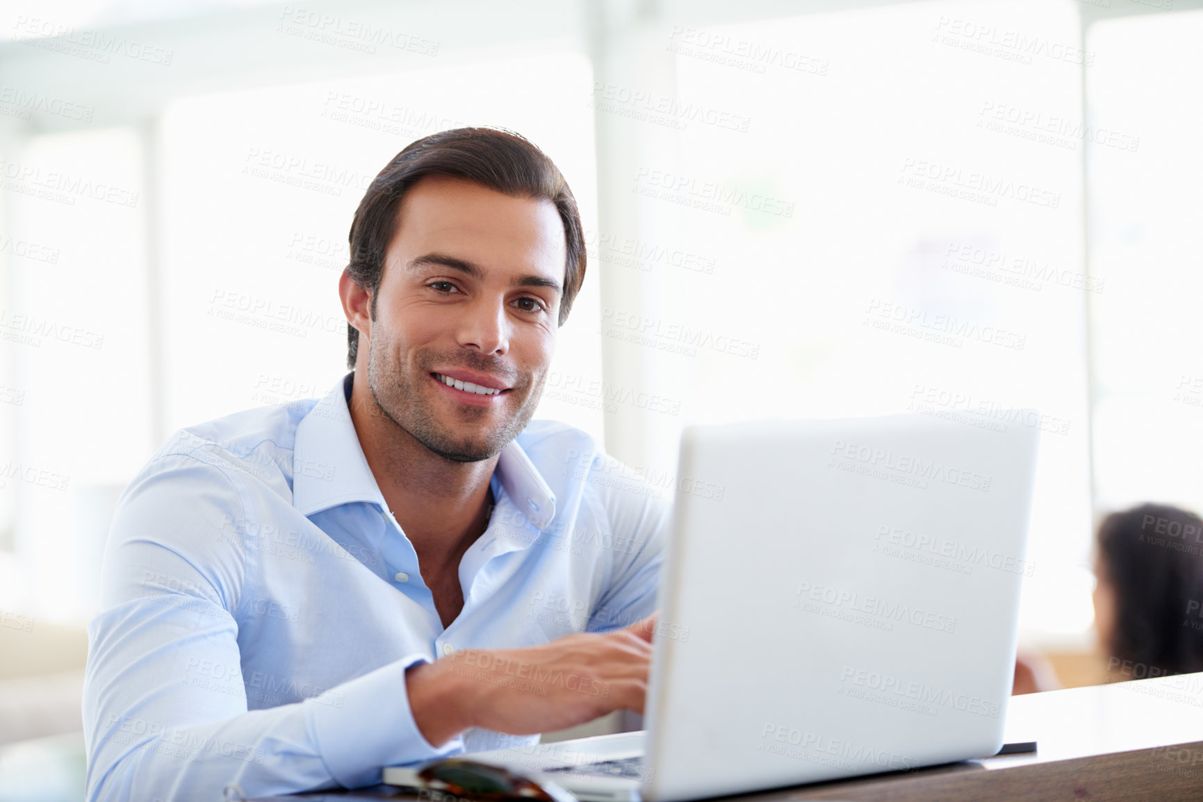 Buy stock photo Portrait of a handsome businessman using his laptop in the office