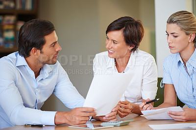 Buy stock photo Shot of business colleagues discussing work during a meeting