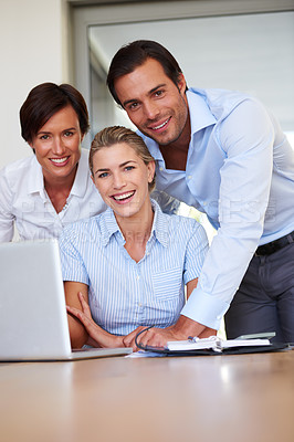 Buy stock photo Portrait of a group of business colleagues huddled by  a laptop