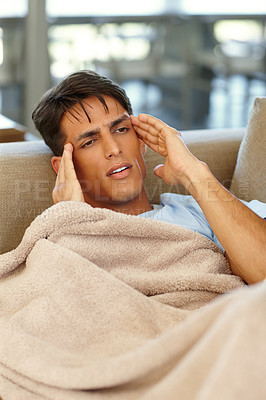 Buy stock photo Shot of a young man suffering from a headache