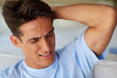 Buy stock photo Shot of a young man suffering from a headache