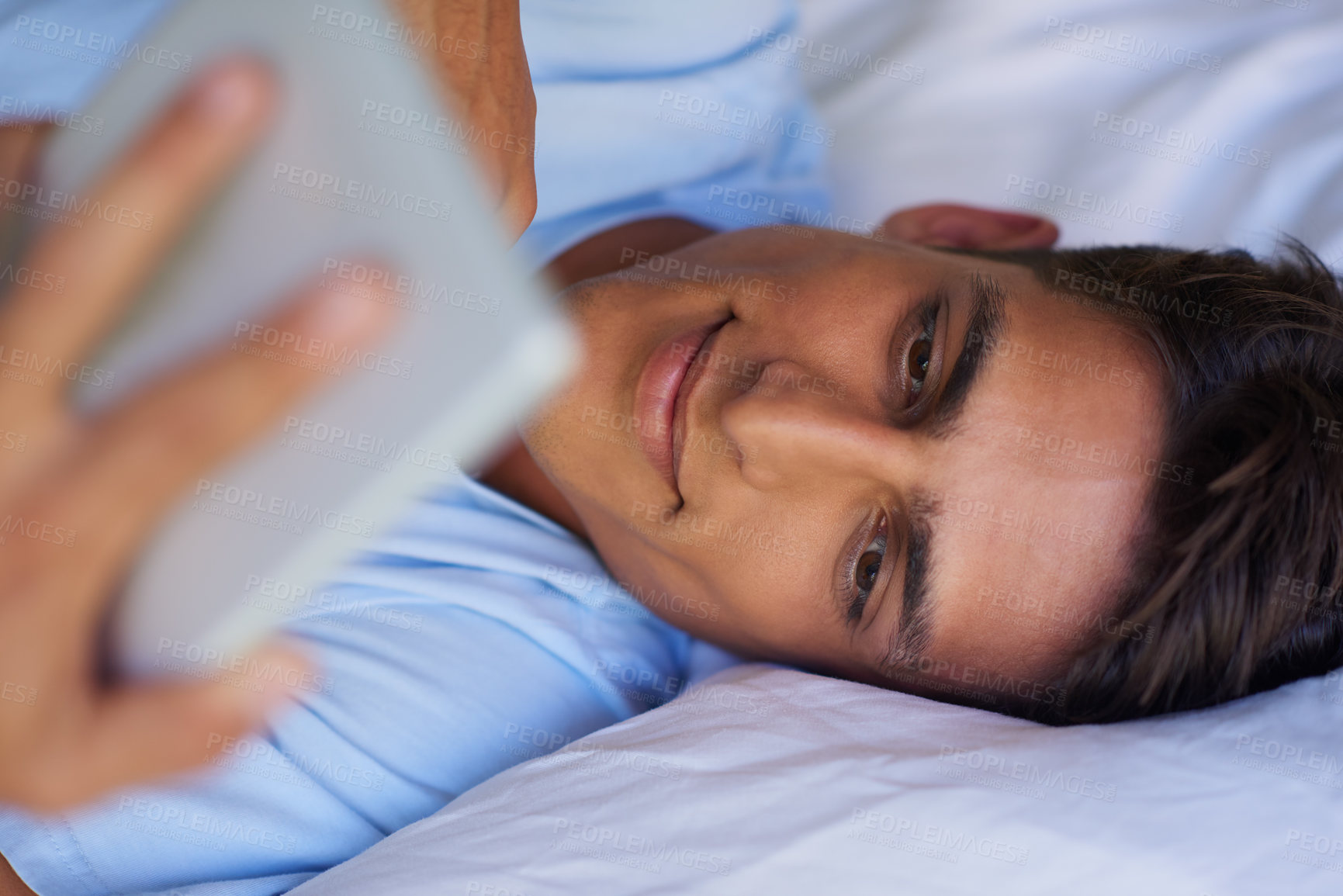 Buy stock photo Cropped shot of a handsome young man using his digital tablet at home