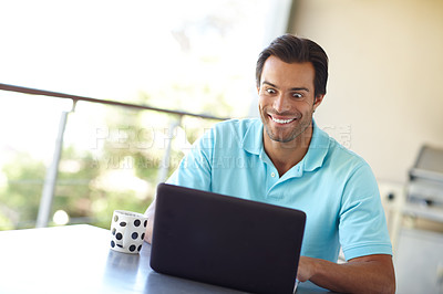 Buy stock photo Shot of a man staring gleefully at his laptop screen