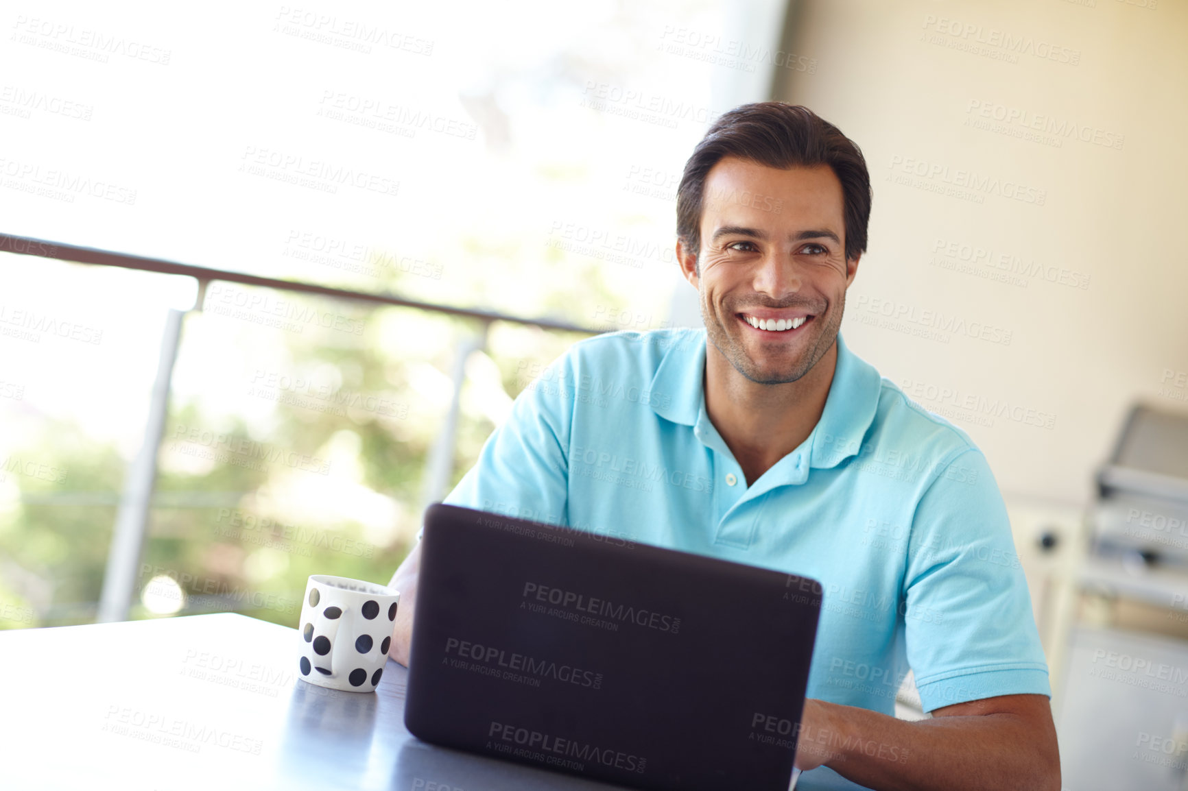 Buy stock photo Shot of a handsome man contemplating something while sitting with his laptop