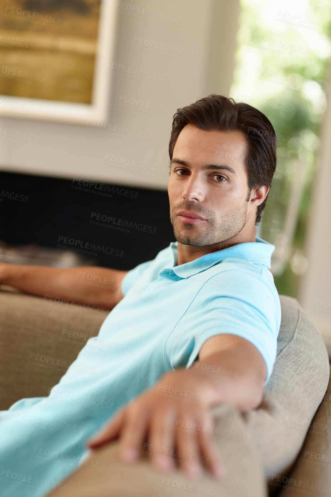 Buy stock photo Portrait of a handsome man sitting on the sofa at home