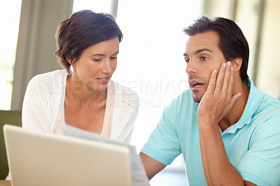 Buy stock photo Shot of a couple discussing their home finances
