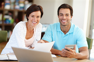 Buy stock photo Portrait of a married couple working on their budget at home