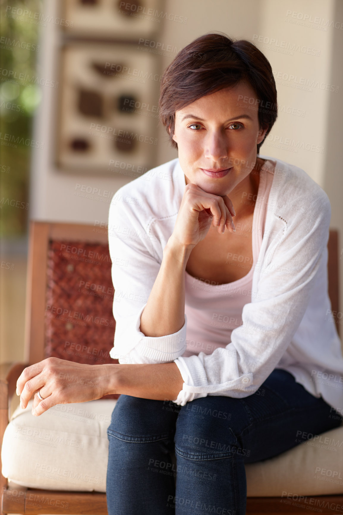 Buy stock photo Portrait of an attractive woman sitting confidently indoors