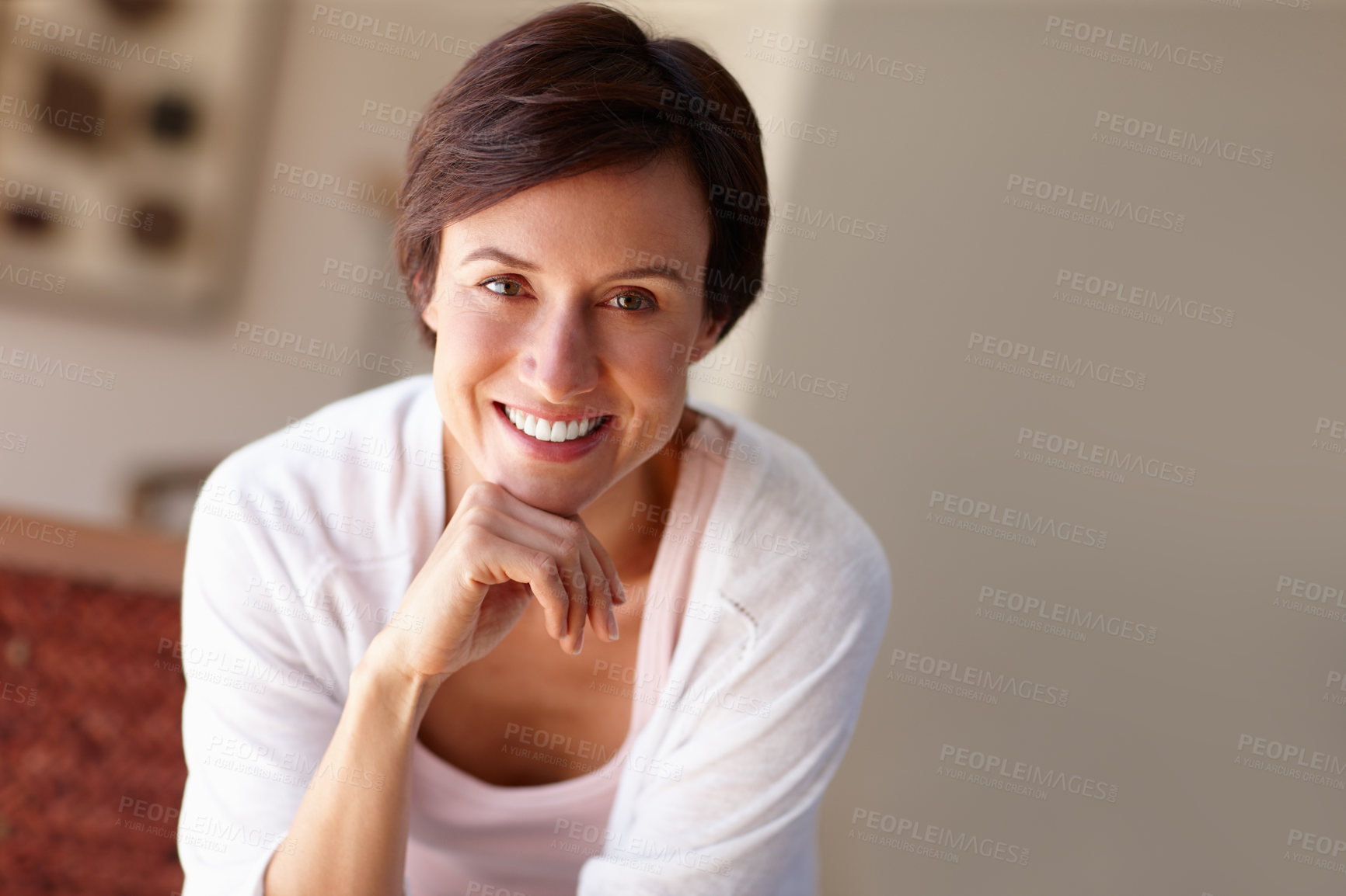 Buy stock photo Portrait of an attractive woman sitting with her hand on her chin