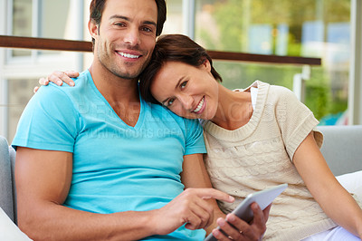 Buy stock photo Portrait of a couple sitting on the sofa with a tablet