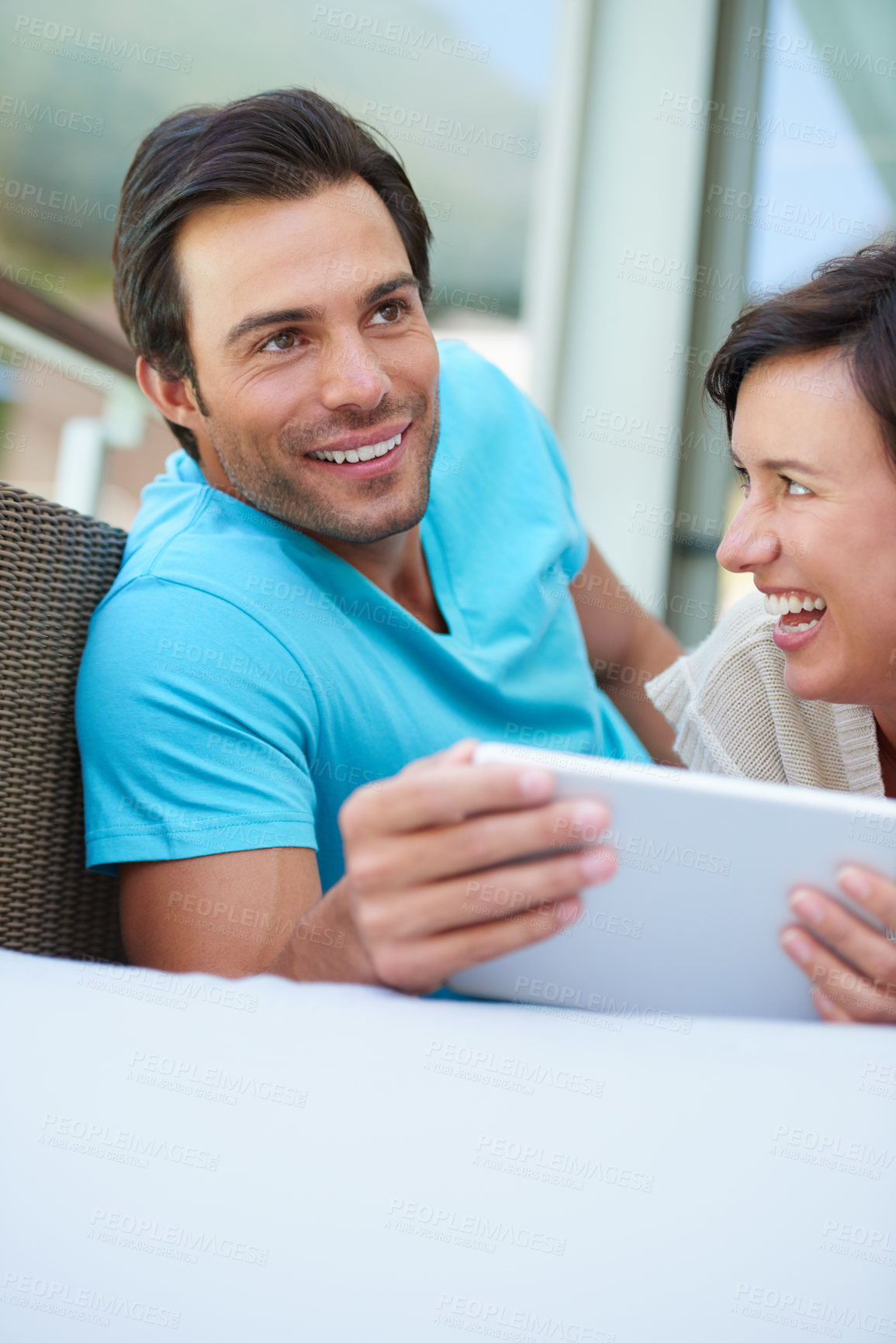 Buy stock photo Shot of a couple relaxing on the sofa with a tablet