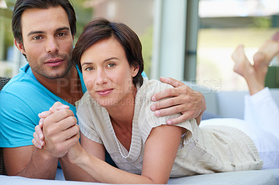 Buy stock photo Portrait of a loving married couple relaxing together on the sofa at home