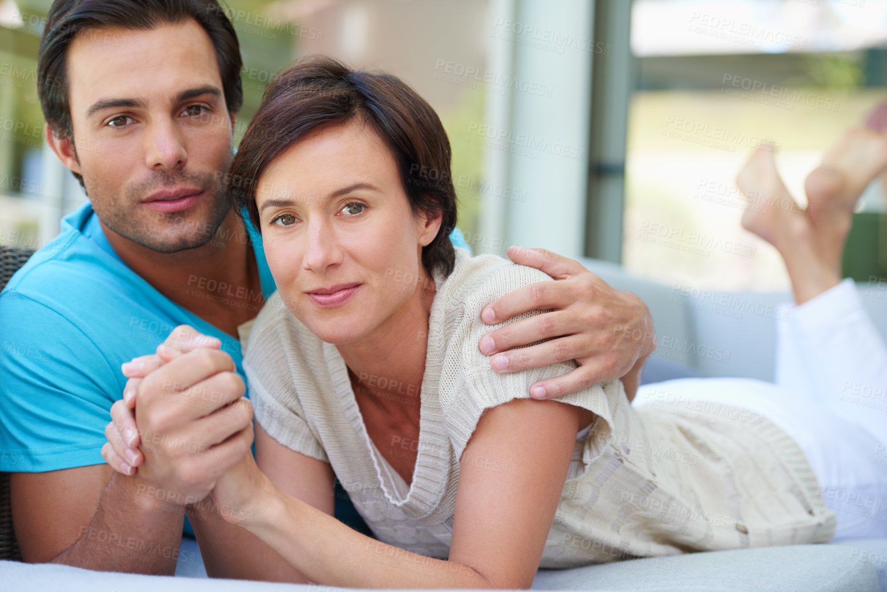 Buy stock photo Portrait of a loving married couple relaxing together on the sofa at home