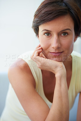 Buy stock photo Portrait of a confident and attractive woman sitting with her hand on her chin