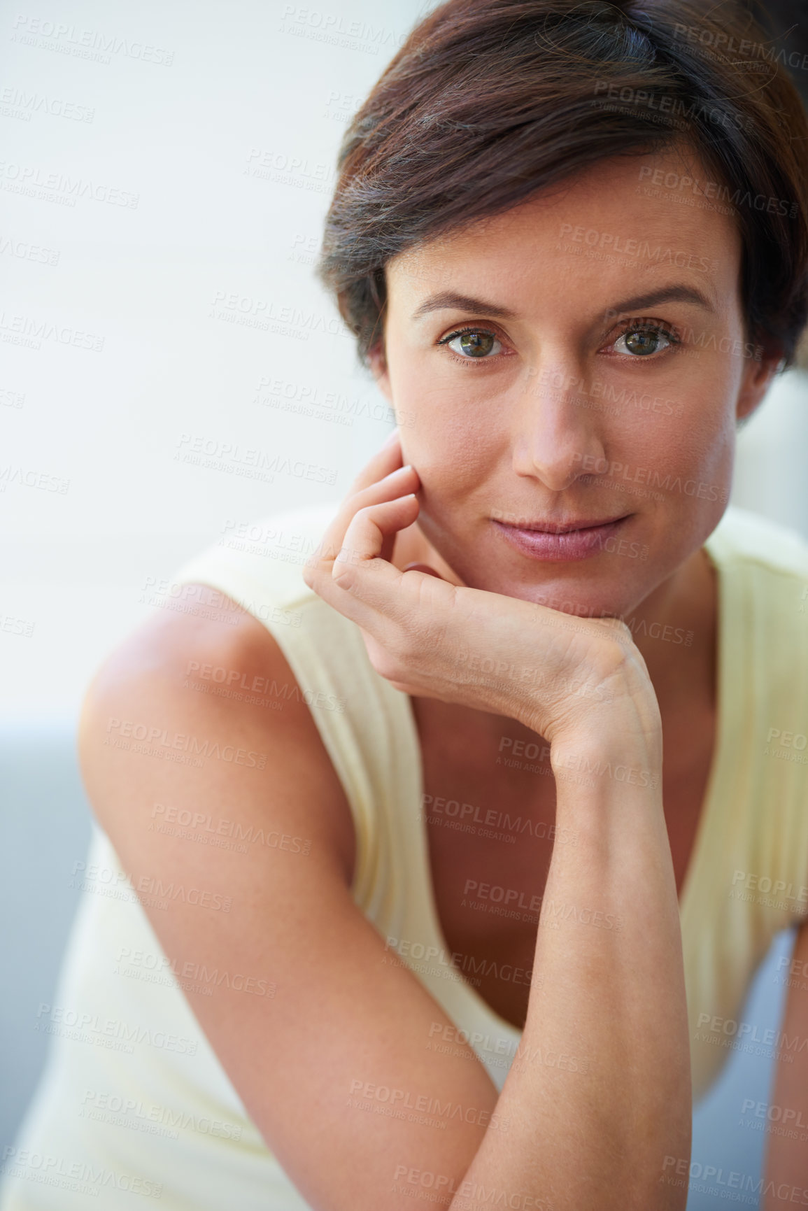 Buy stock photo Portrait of a confident and attractive woman sitting with her hand on her chin