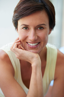 Buy stock photo Portrait of a confident and attractive woman sitting with her hand on her chin
