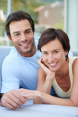 Buy stock photo Portrait of a loving married couple relaxing together on the sofa at home