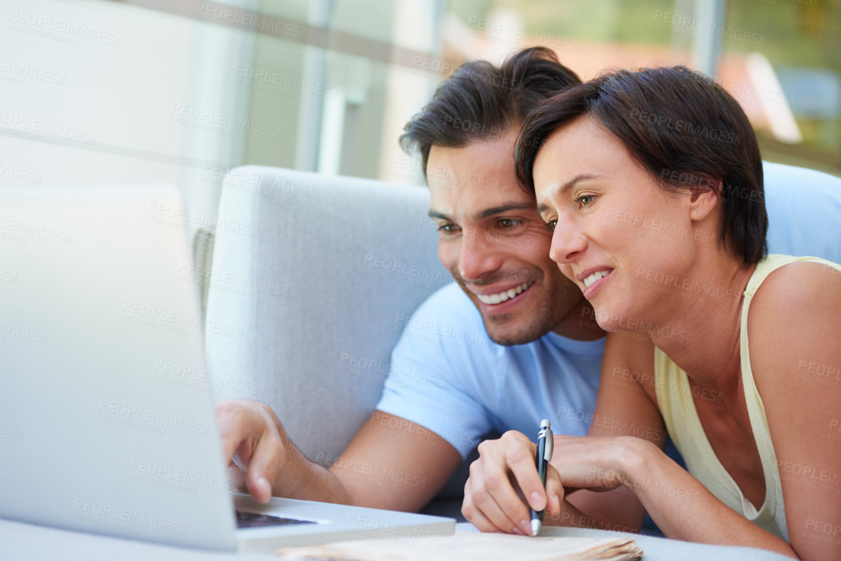 Buy stock photo Shot of a married couple working on their household budget on their computer