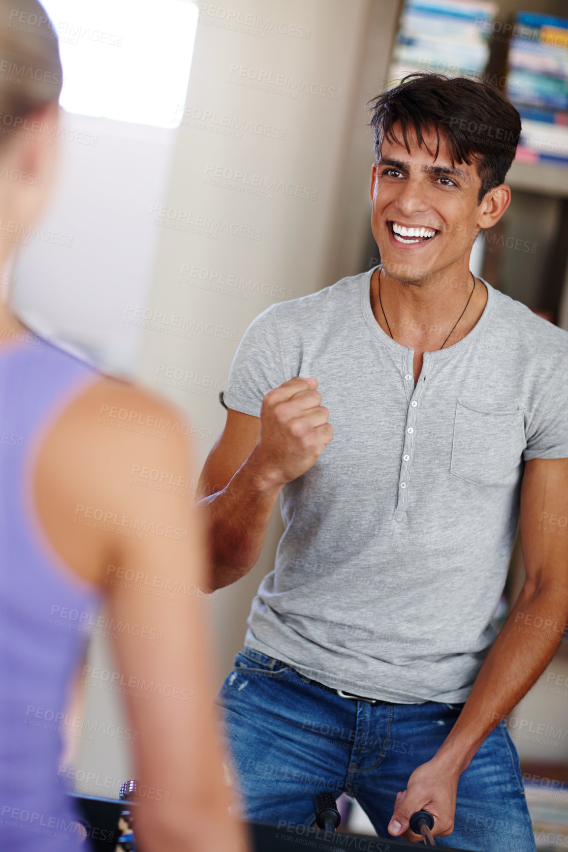 Buy stock photo Shot of an excited young man making a fist pump while facing his girlfriend