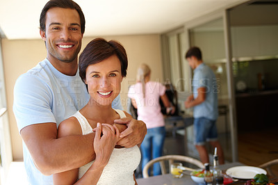 Buy stock photo Shot of a couple enjoying a barbeque at their friends' place