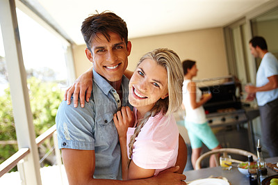 Buy stock photo Shot of a young couple enjoying a barbeque at their friends' place