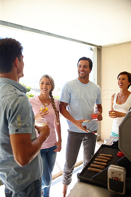 Buy stock photo Shot of a group of friends enjoying a barbeque over the weekend