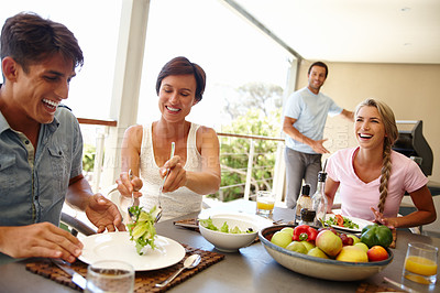 Buy stock photo Shot of a group of friends enjoying a meal together