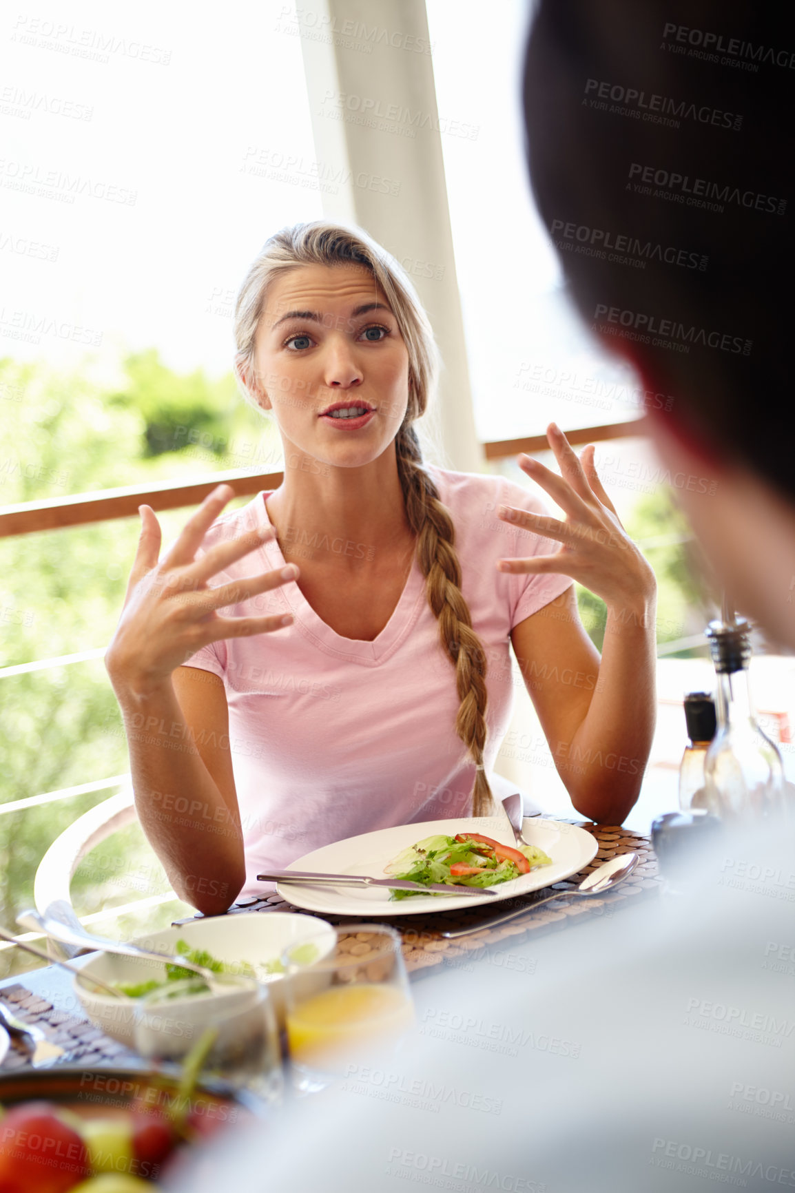 Buy stock photo Shot of an attractive woman having an animated conversation with someone during lunch