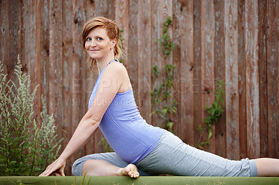 Buy stock photo Portrait of an attractive woman doing yoga outdoors