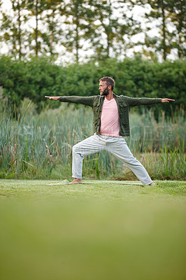 Buy stock photo Man, yoga and warrior pose at park, nature and balance with mindfulness, wellness and peace on grass. Mature person, zen and meditation in spring with stretching, breathing and profile in France