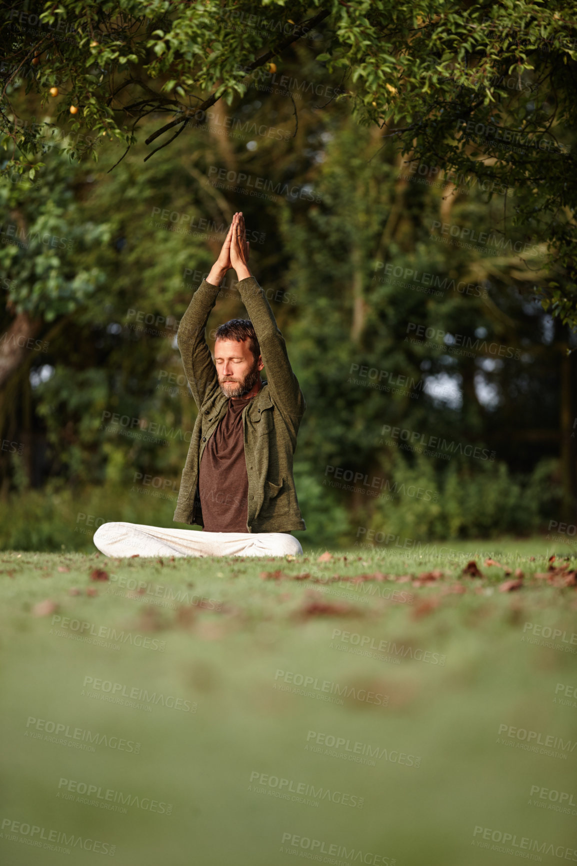 Buy stock photo Shot of a handsome mature man doing yoga in the outdoors