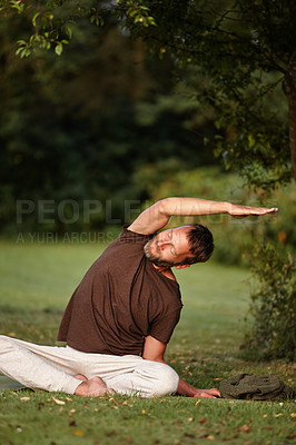 Buy stock photo Yoga, stretching and zen with man in nature for parighasana pose, peace and exercise balance. Wellness, workout and flexible with person on lawn of spiritual retreat for mindfulness, relax and calm