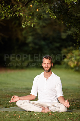 Buy stock photo Portrait of a handsome mature man sitting in the lotus position in nature