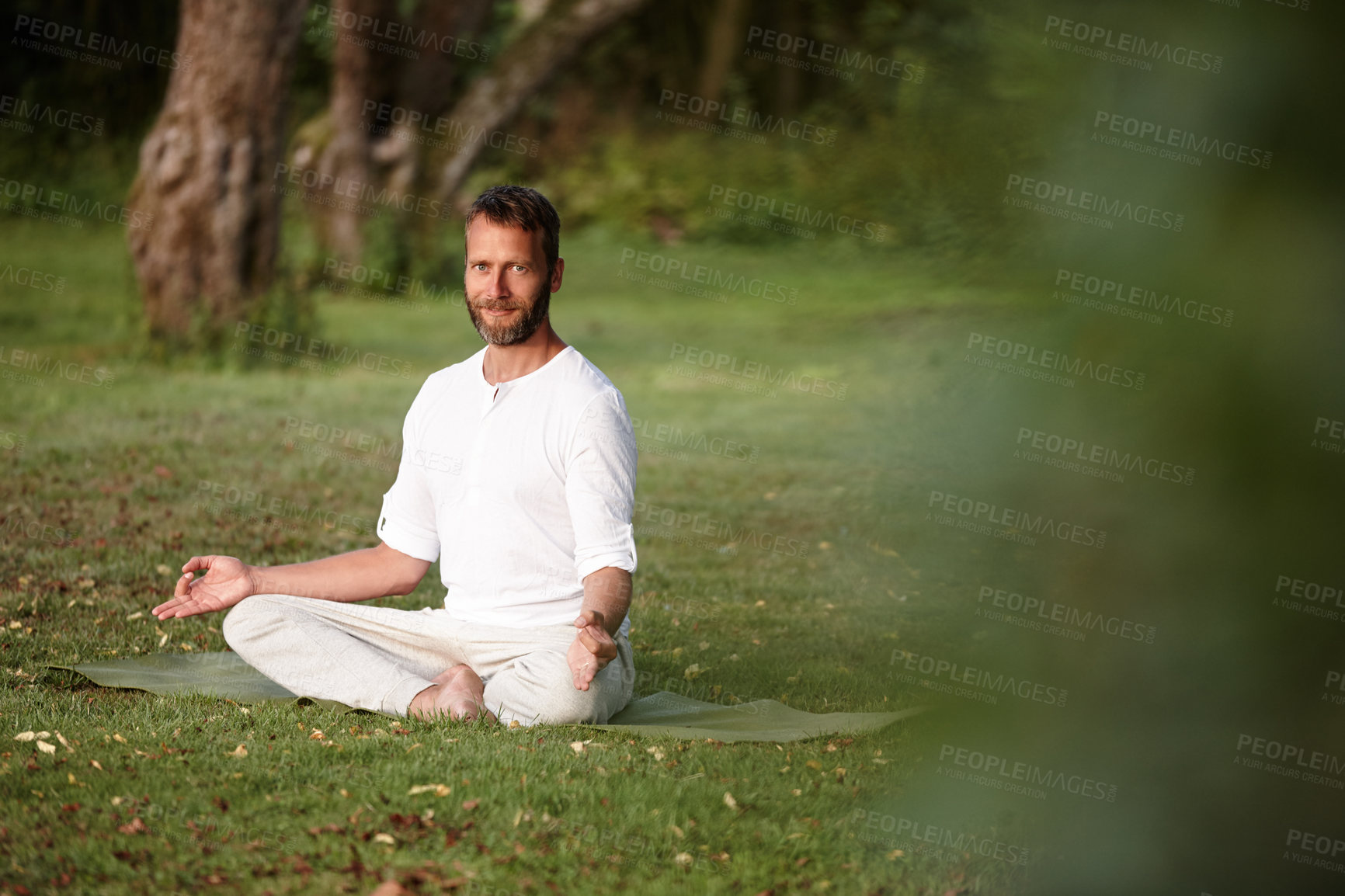 Buy stock photo Portrait, health and meditation with man in nature for lotus pose, peace and exercise balance. Wellness, yoga and fitness with person on lawn of spiritual retreat for mindfulness, calm or zen