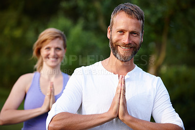 Buy stock photo Portrait of a handsome mature man doing yoga with his partner in the outdoors