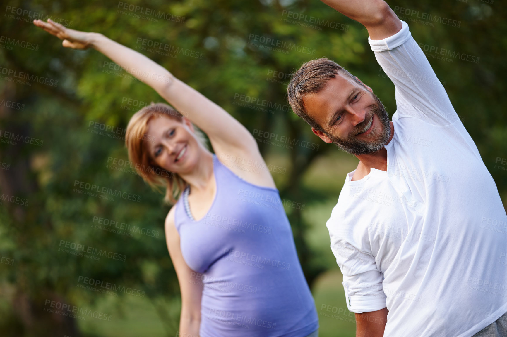 Buy stock photo Shot of a happy mature couple doing yoga in nature