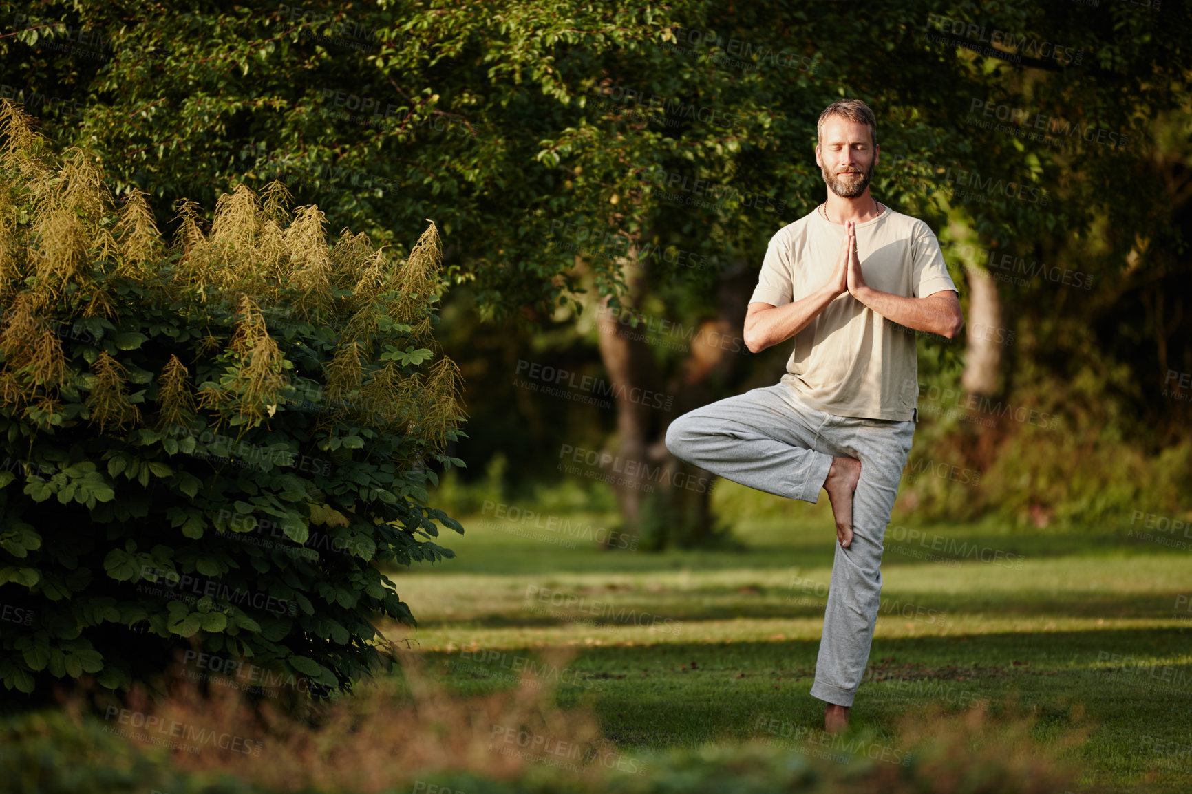 Buy stock photo Shot of a handsome mature man enjoying a yoga session in nature