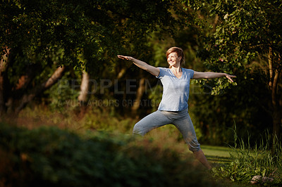 Buy stock photo Shot of an attractive woman doing yoga in the outdoors