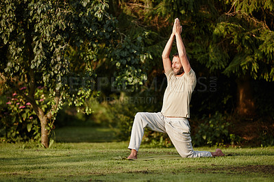 Buy stock photo Full length shot of a handsome mature man doing yoga in the outdoors