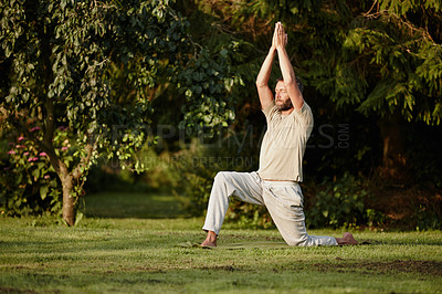 Buy stock photo Full length shot of a handsome mature man doing yoga in the outdoors