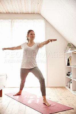 Buy stock photo Shot of an attractive young woman doing yoga at home