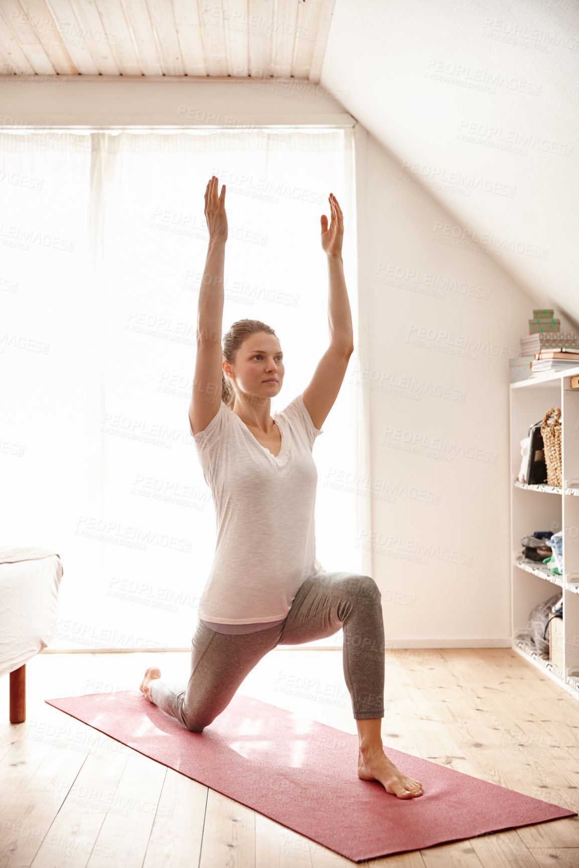 Buy stock photo Shot of an attractive young woman doing yoga at home