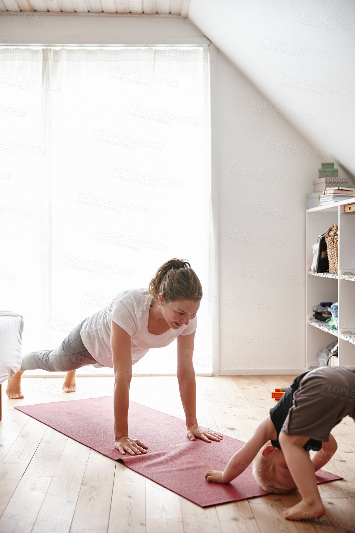 Buy stock photo Shot of a young woman and her son doing yoga together at home