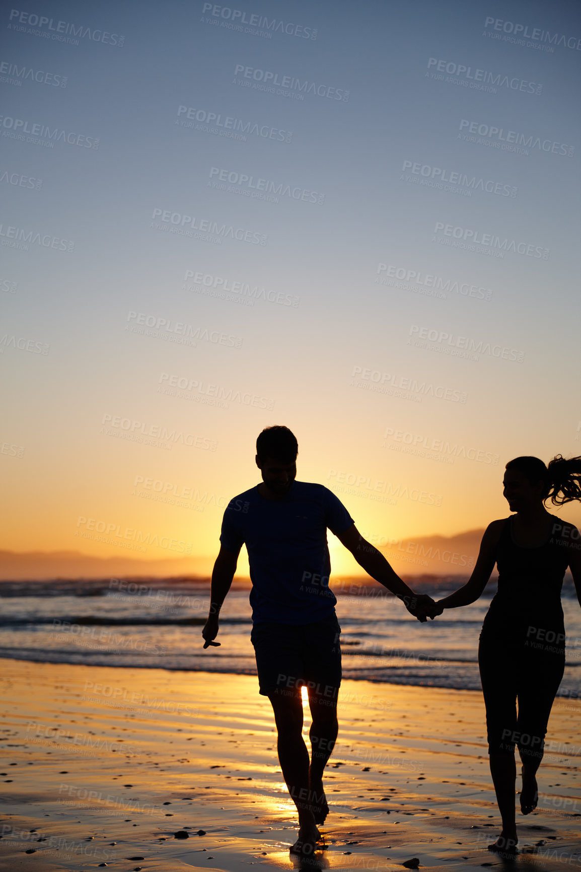 Buy stock photo Silhouette image of a couple running and holding hands at sunrise