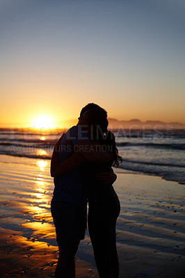 Buy stock photo Silhouette image of a couple hugging and kissing at sunrise