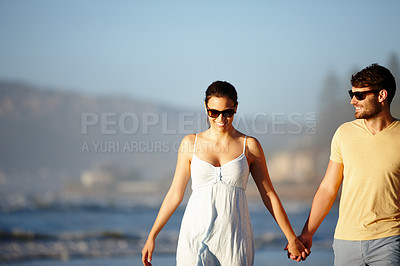 Buy stock photo Shot of a happy couple enjoying some time together on the beach